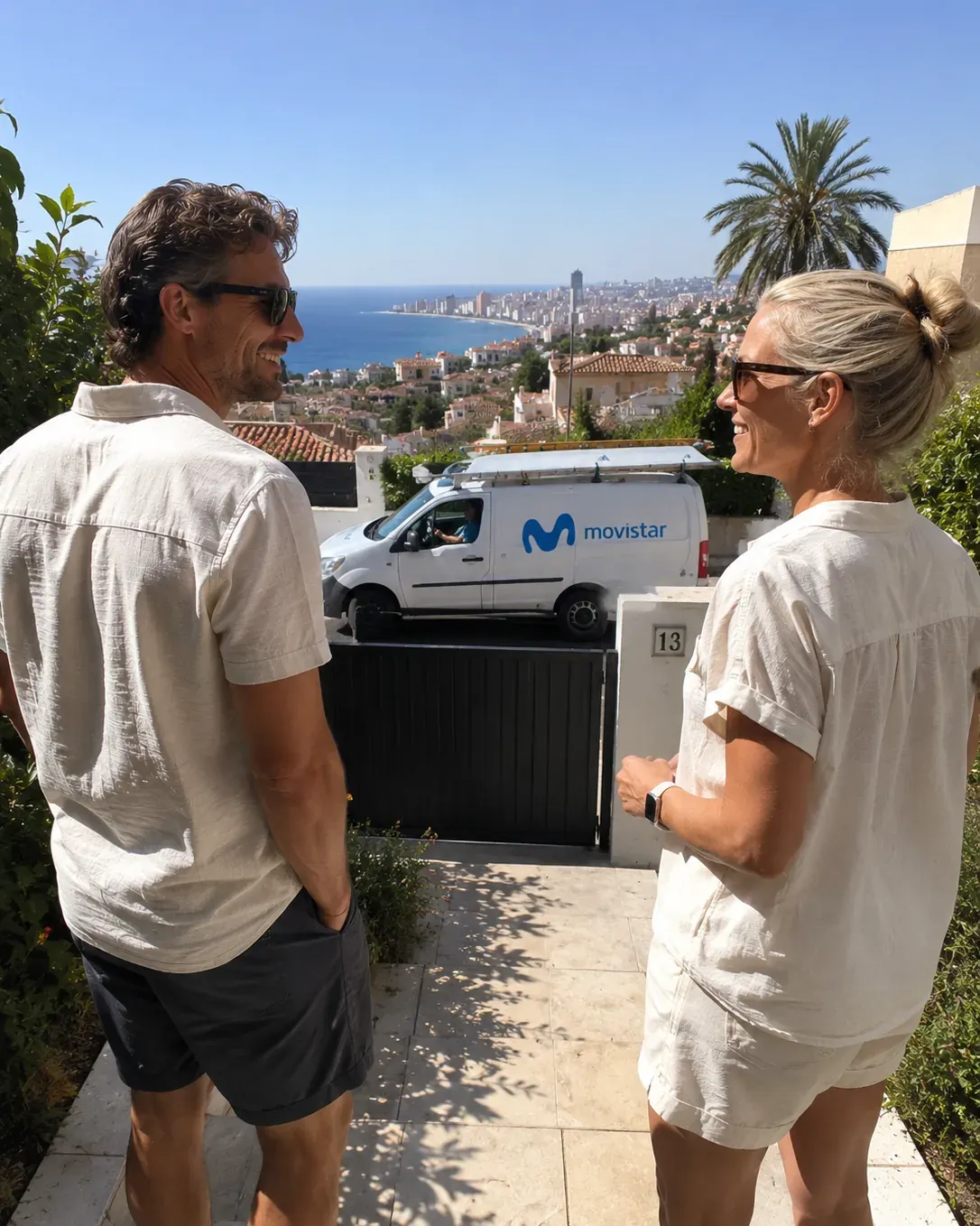 A couple comparing internet providers in Alicante with the city in the background