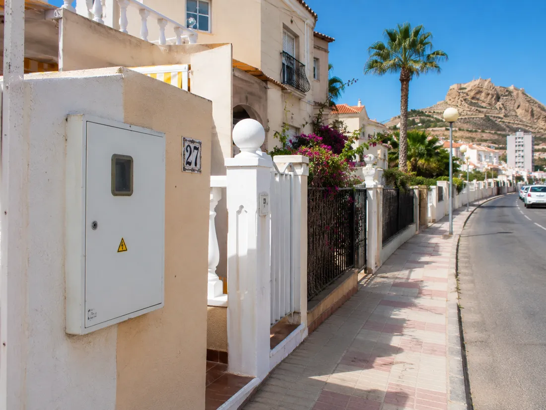 An international homeowner comparing Endesa electricity setup documents in Spain