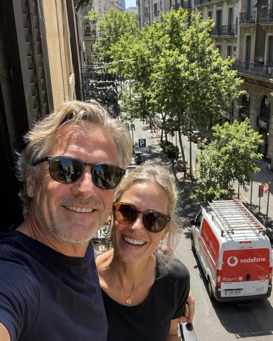 A couple comparing internet providers in Barcelona with the city in the background